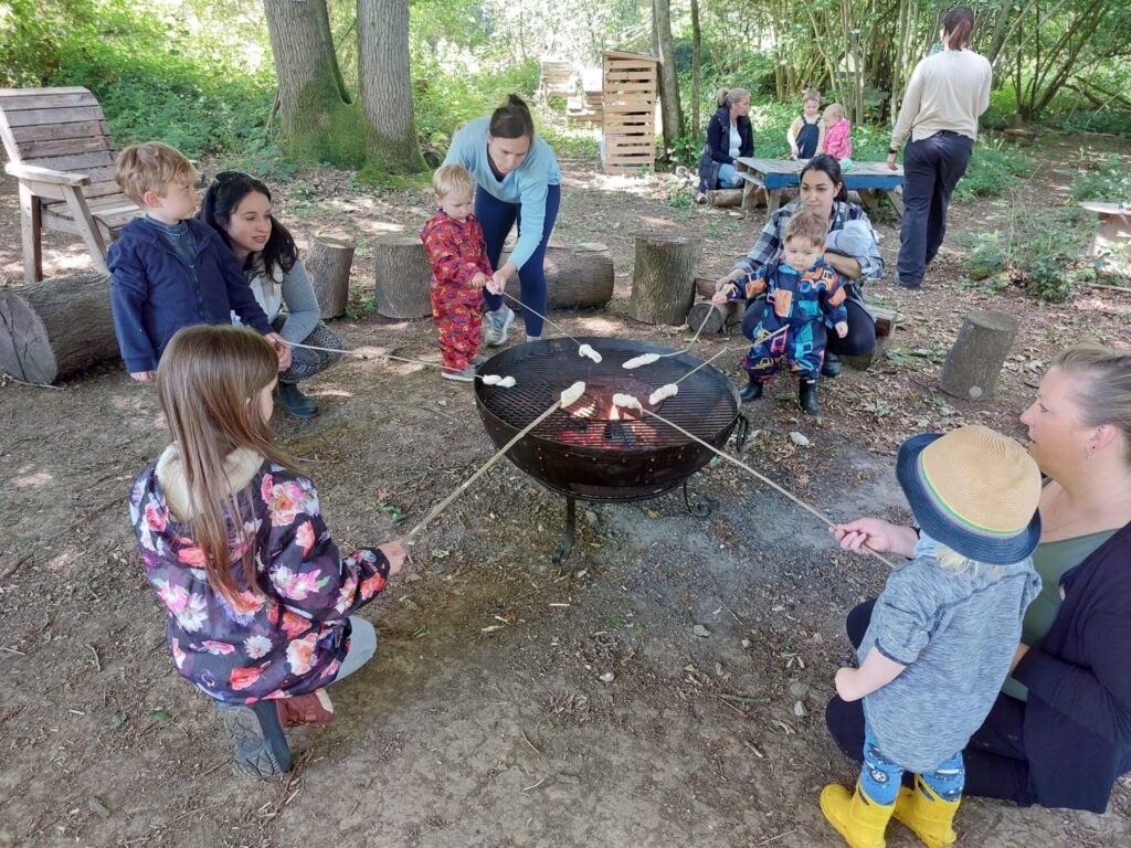 Outdoor school trip mashmallows round the fire